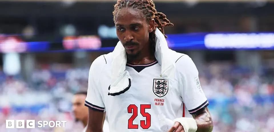 Player in England jersey walking off the field