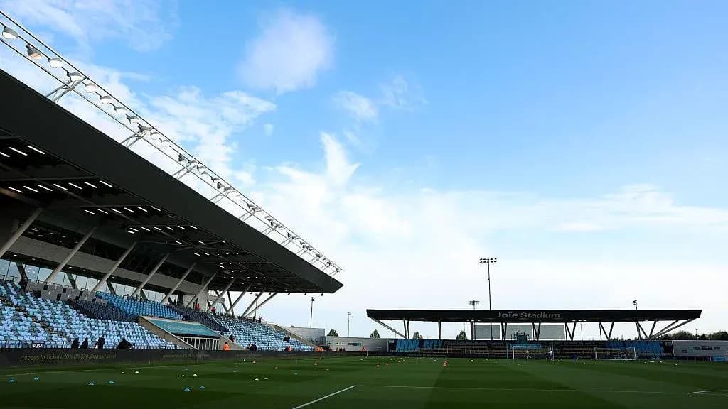 Joie Stadium with empty stands and clear sky
