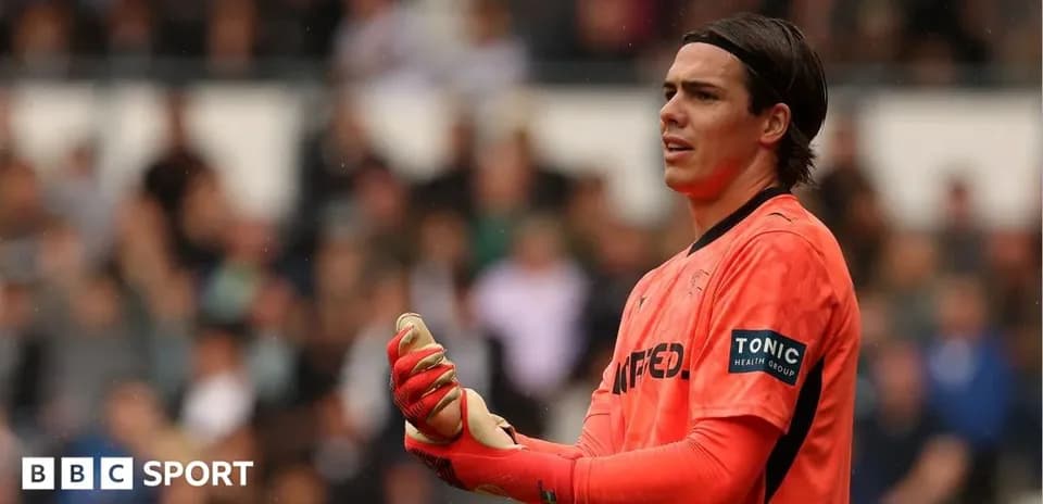 Goalkeeper in orange kit during a match
