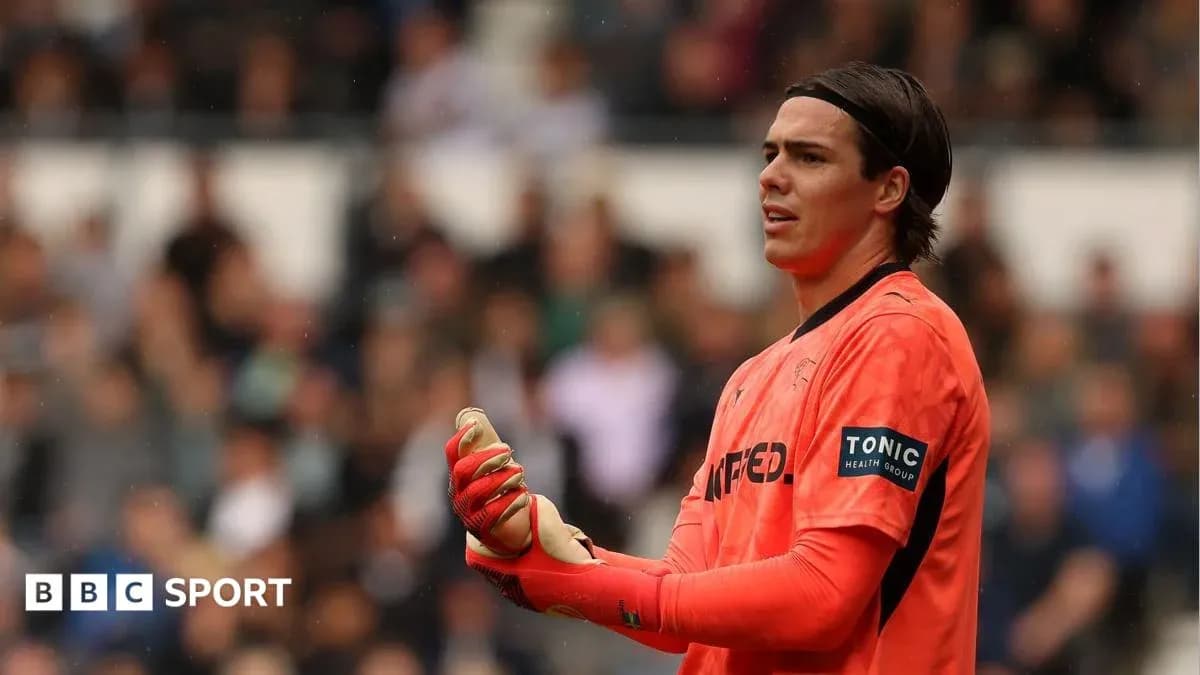 Goalkeeper in orange kit during a match