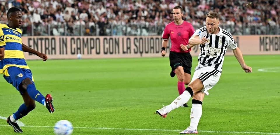Juventus player kicking ball against Parma