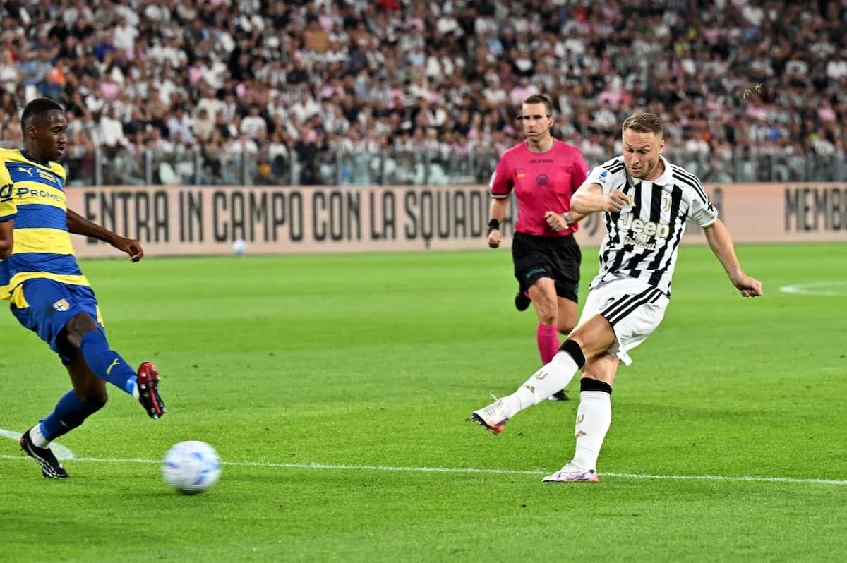 Juventus player kicking ball against Parma