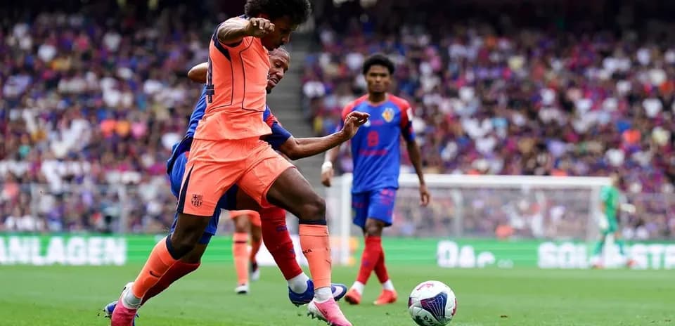 Player in orange tackling opponent during match
