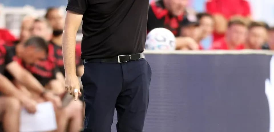 Coach directing players from the sidelines during match