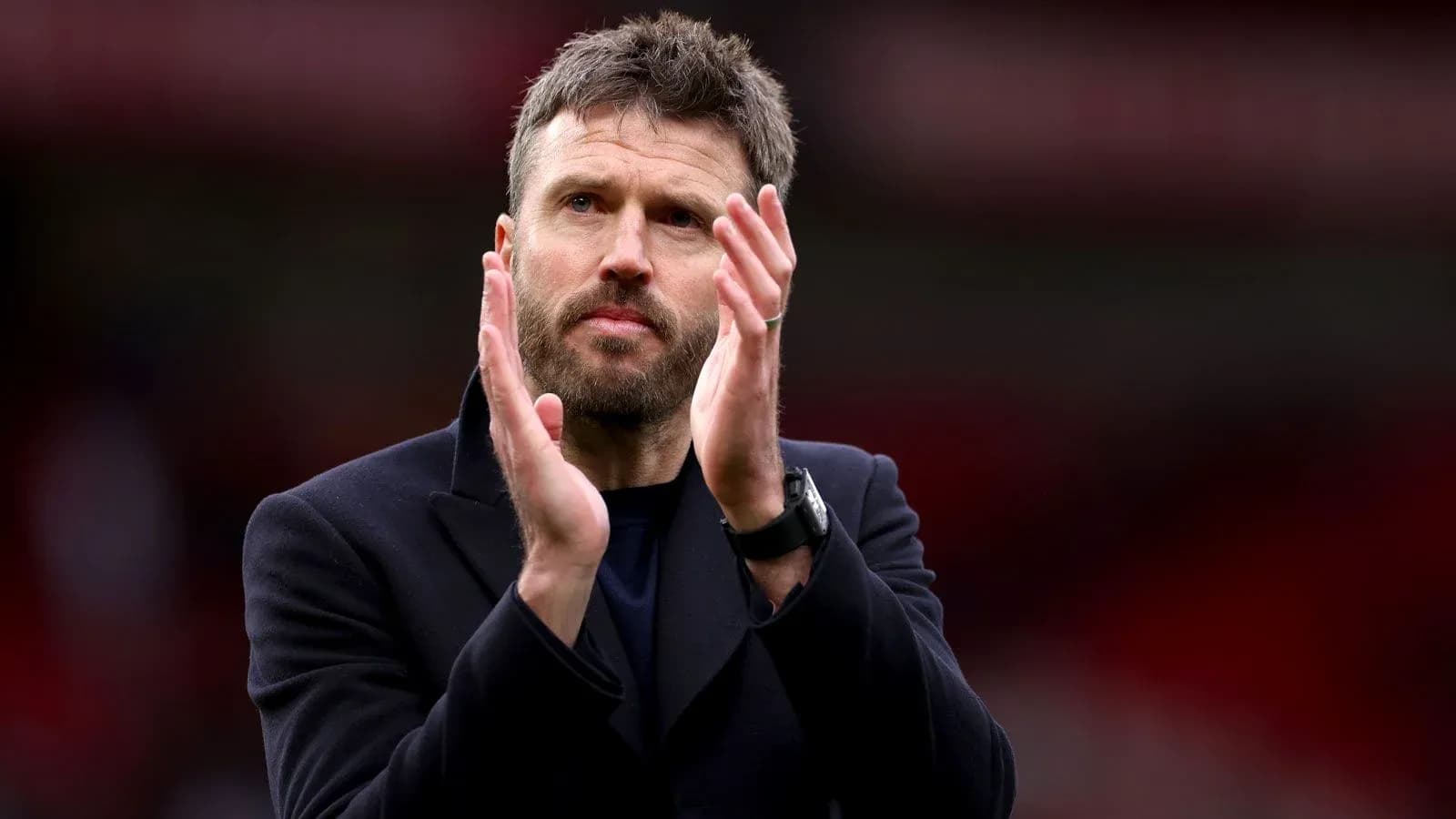 Coach applauding fans after the match