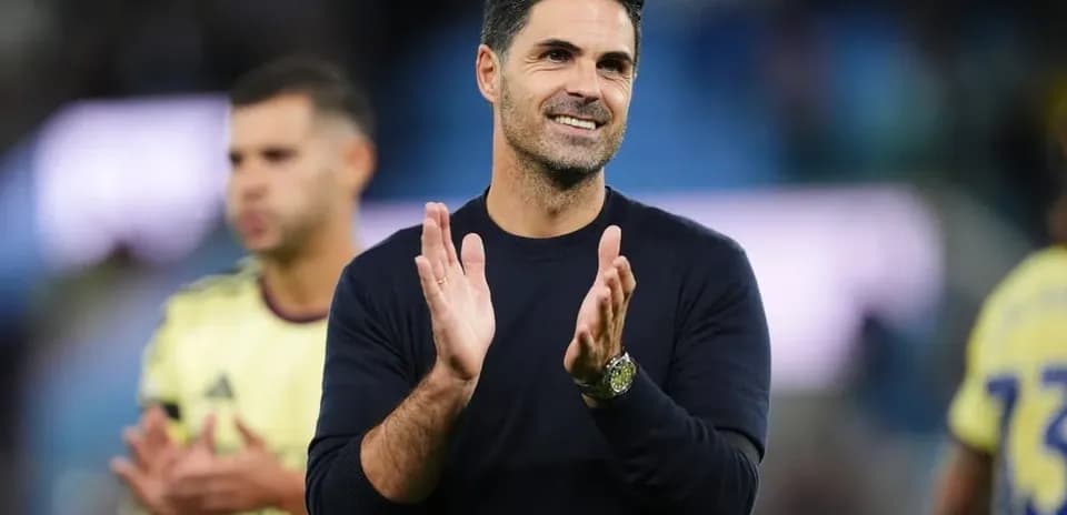 Coach applauding after match with players in background