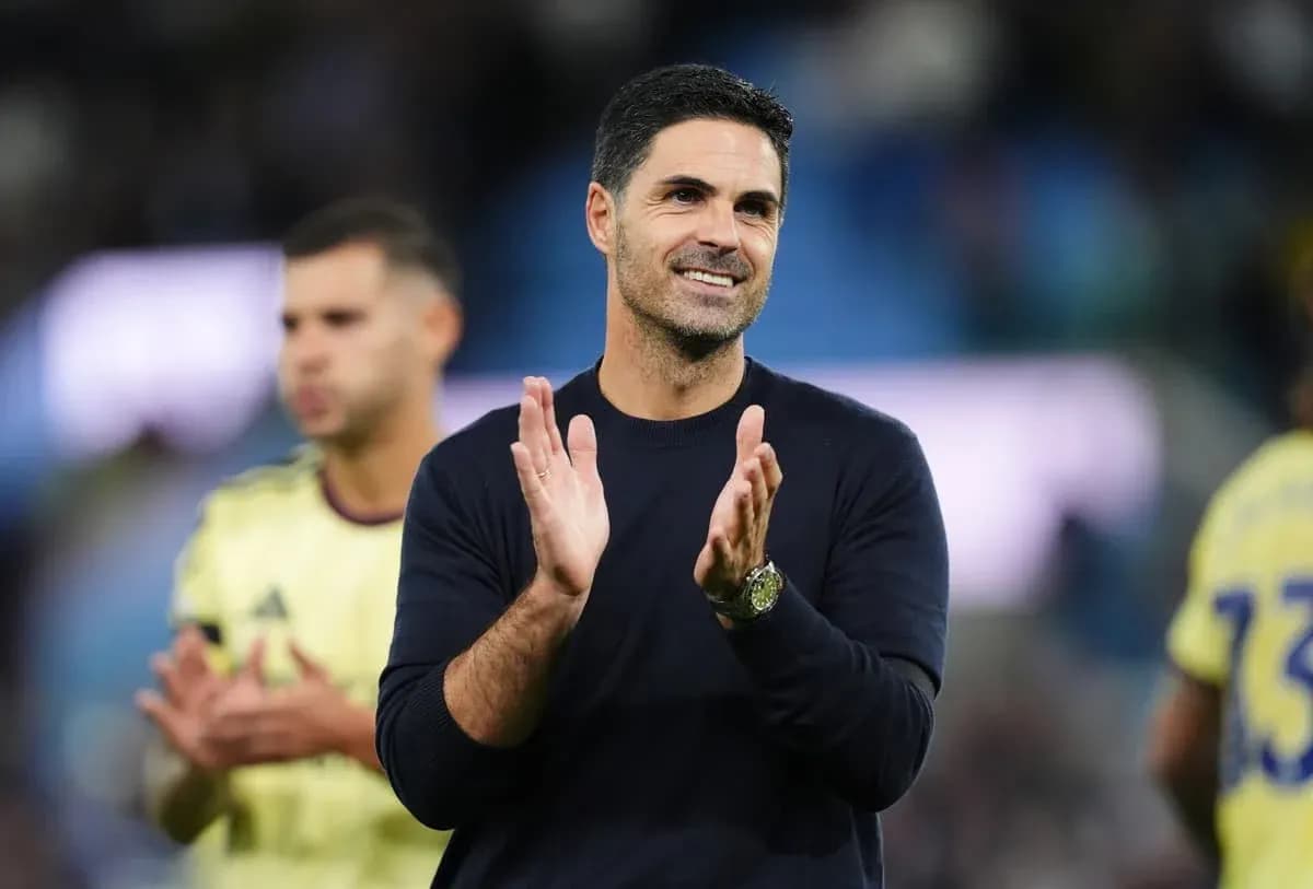 Coach applauding after match with players in background