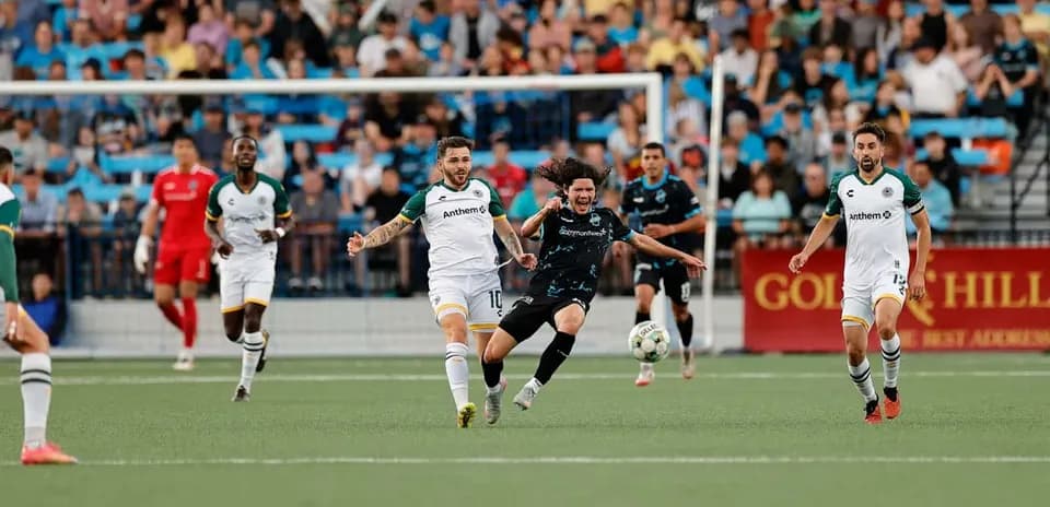 Players competing for the ball during match