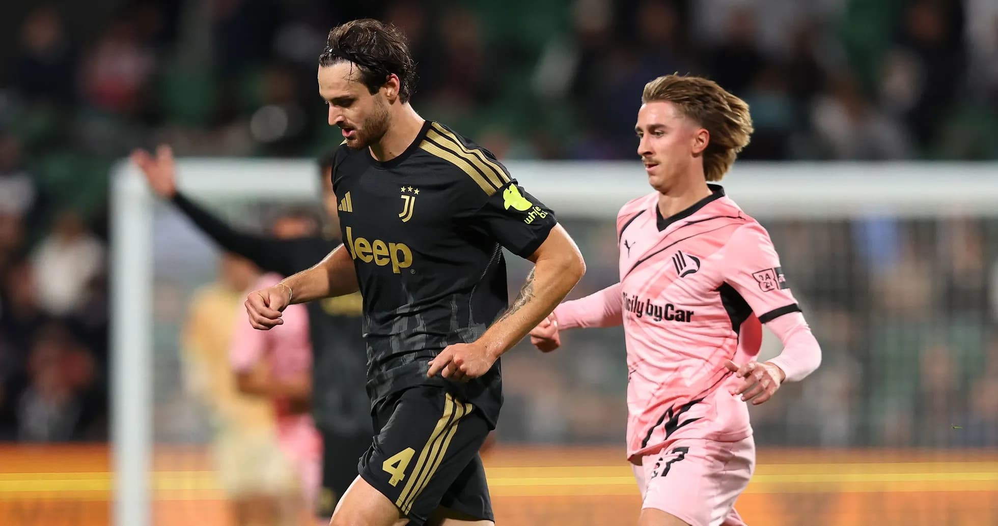 Juventus player running with ball, Swansea player chasing