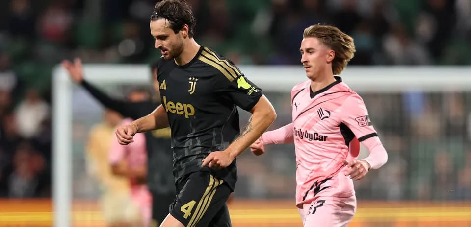 Juventus player running with ball, Swansea player chasing