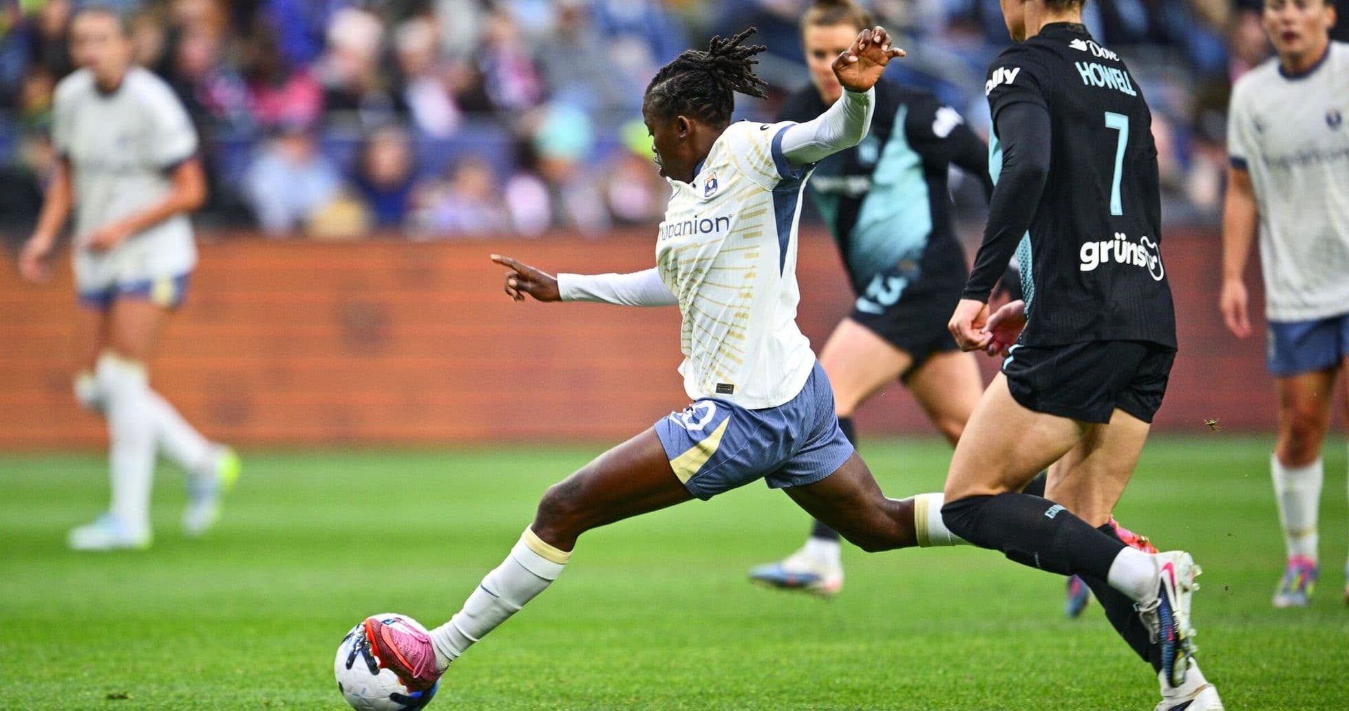 Player kicking ball during Seattle Reign FC match