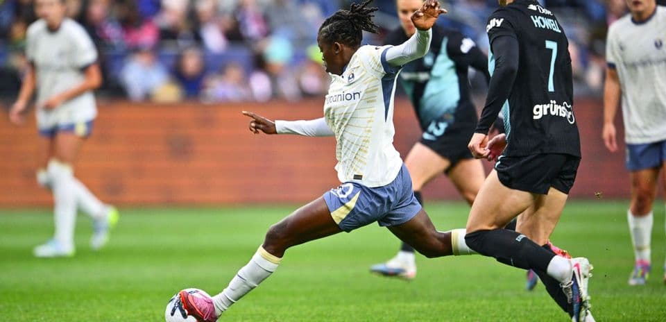 Player kicking ball during Seattle Reign FC match