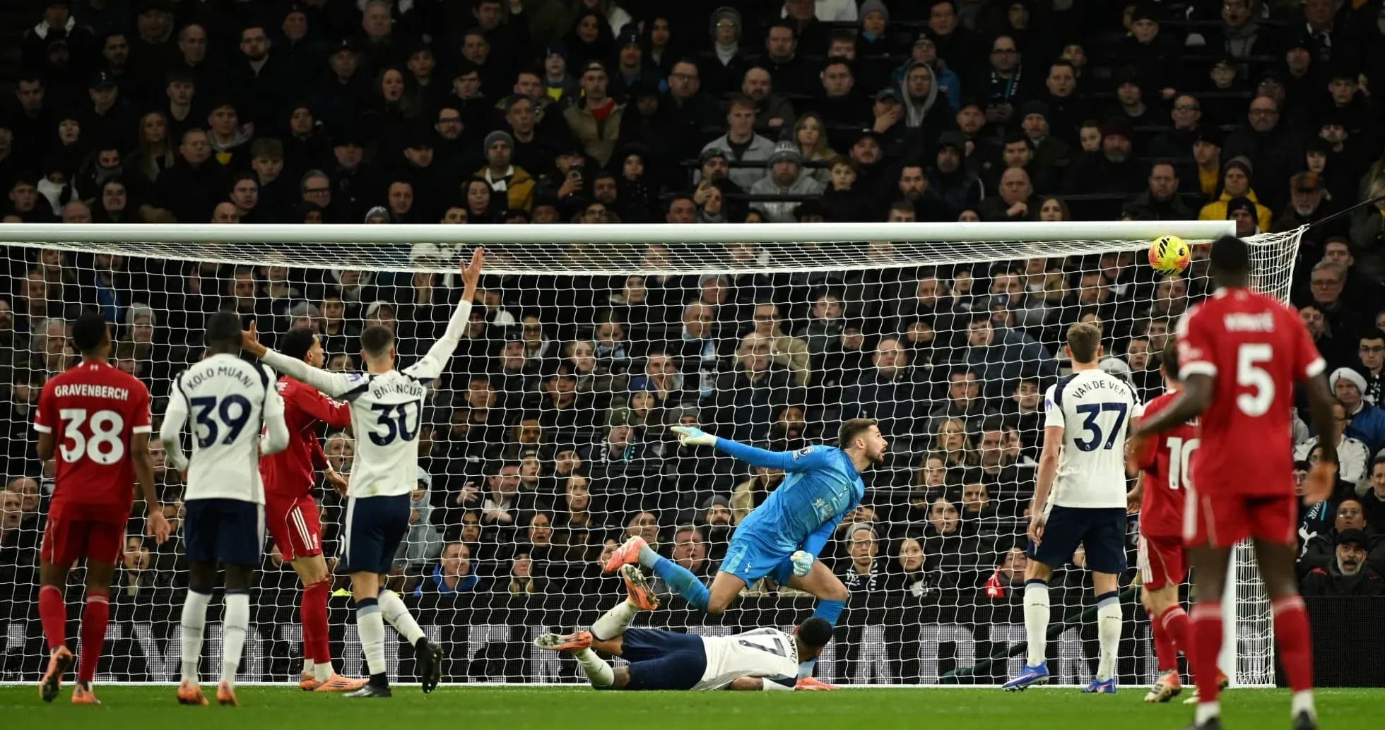 Liverpool player heading the ball towards the goal