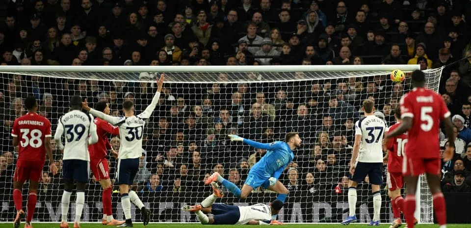Liverpool player heading the ball towards the goal