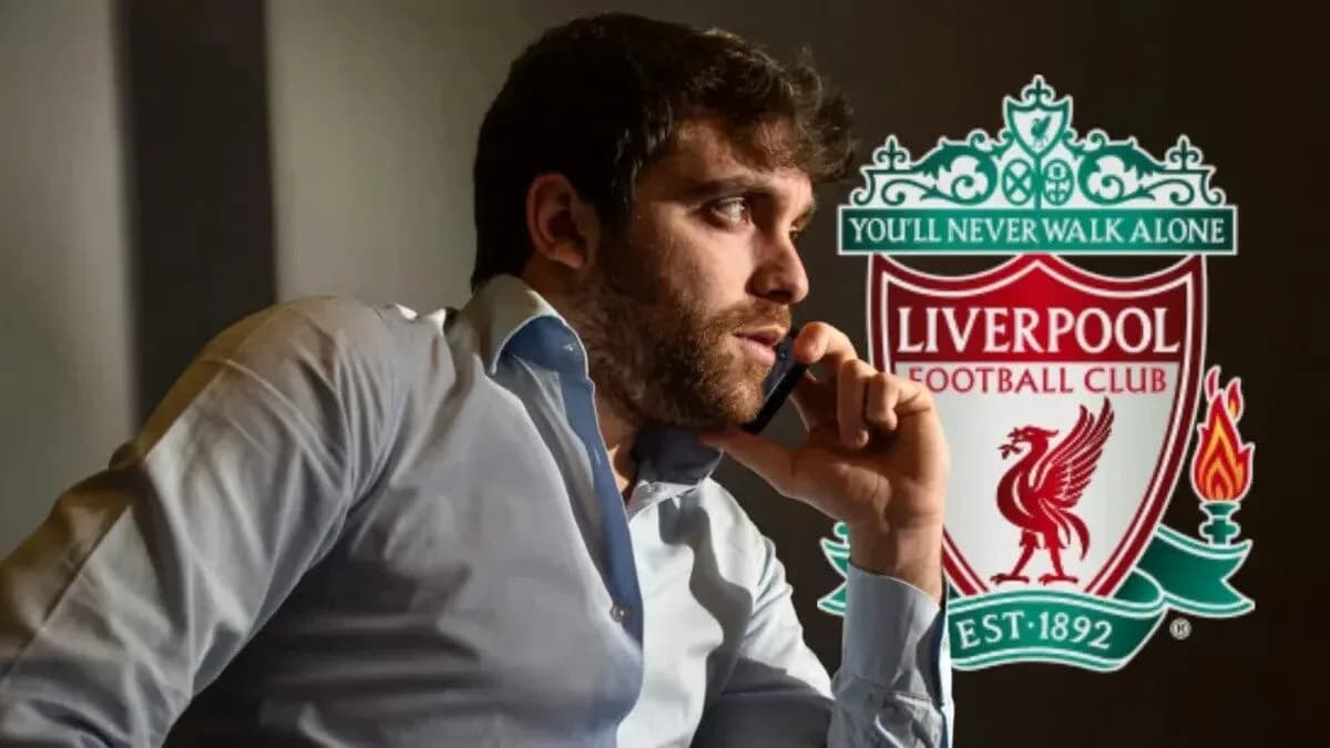 Person on phone with Liverpool FC logo in background