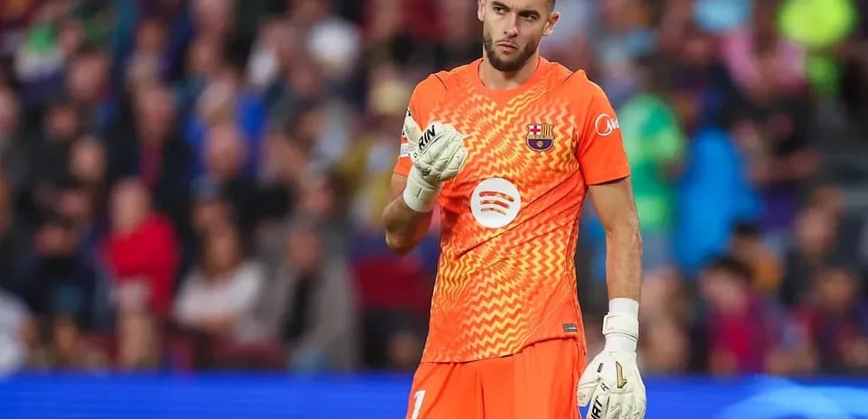 Goalkeeper in orange kit during match at stadium