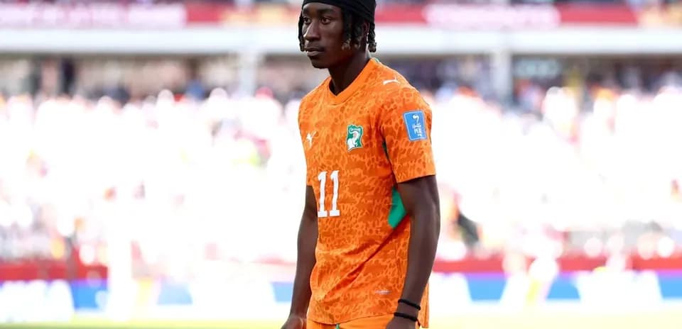 Player in orange jersey standing on the field