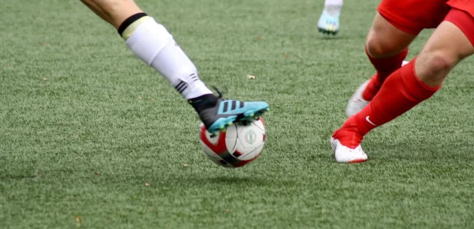 Players competing for the ball in football match