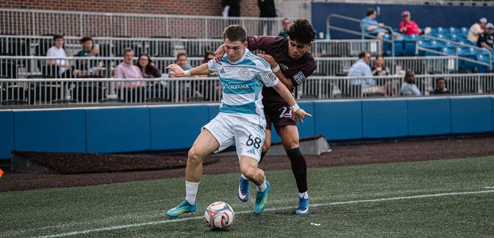 Player battling for possession during MLS Next Pro match