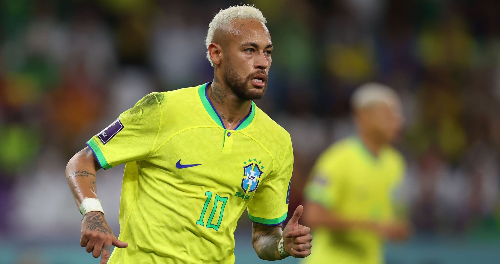 Neymar running in Brazil jersey during match