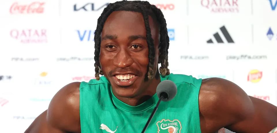 Player speaking at press conference in team jersey