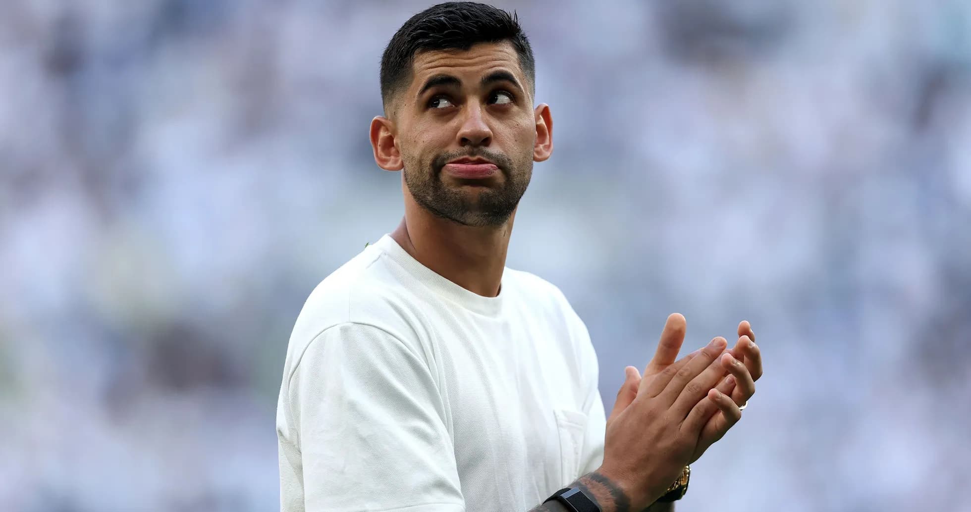 Player clapping and looking up during match