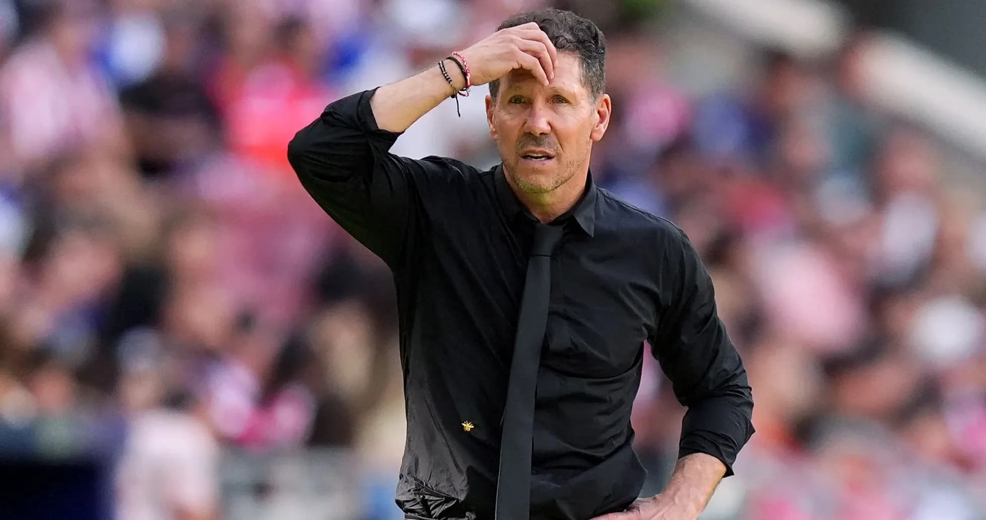 Coach looking concerned on the sidelines during match