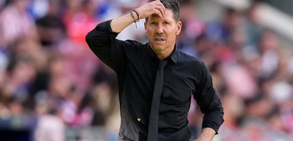 Coach looking concerned on the sidelines during match