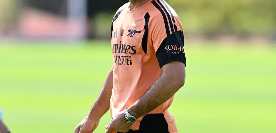 Coach smiling during training session on pitch