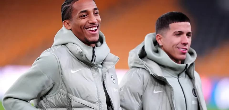 Two players smiling in training jackets before match