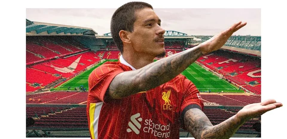 Player gesturing on the pitch at Anfield stadium