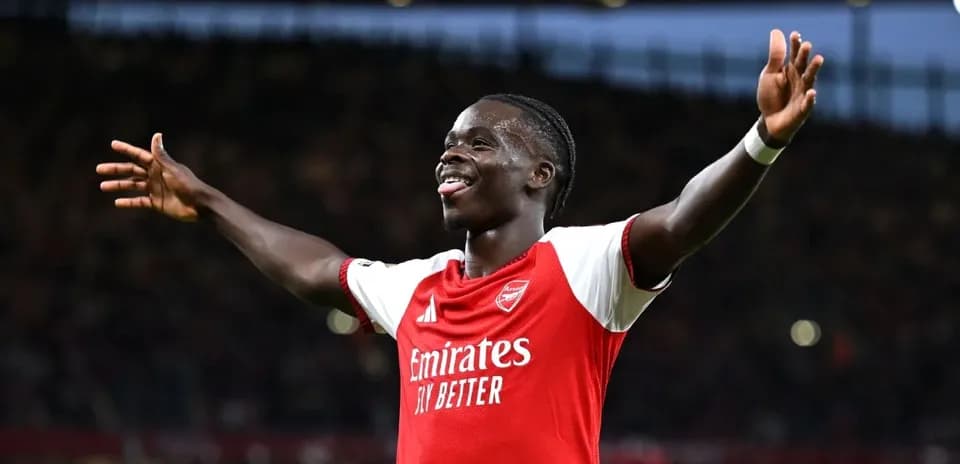 Player celebrating goal with arms outstretched