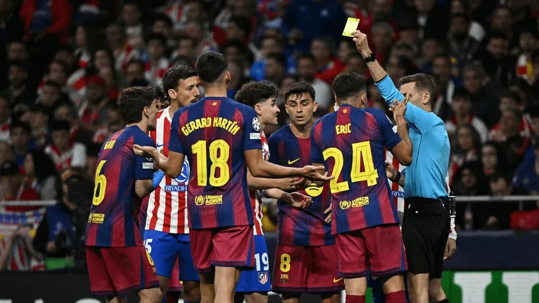Referee showing yellow card to Barcelona players
