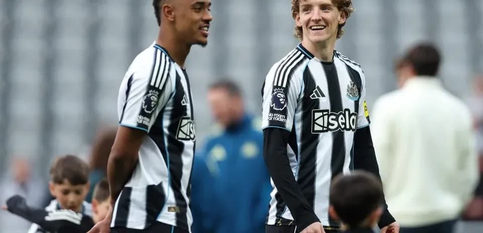Newcastle players interacting on the pitch before match