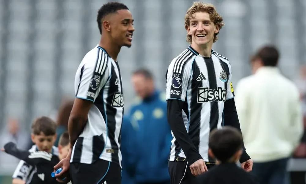 Newcastle players interacting on the pitch before match