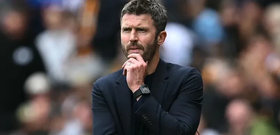 Coach observing match while deep in thought