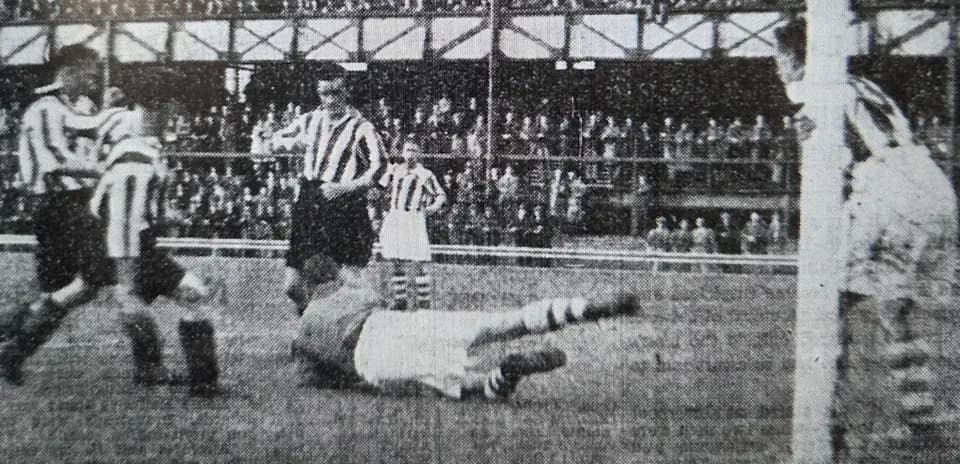 Players contesting near the goal during a match