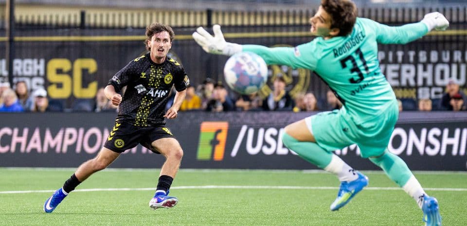 Player shooting on goal during Pittsburgh Riverhounds match