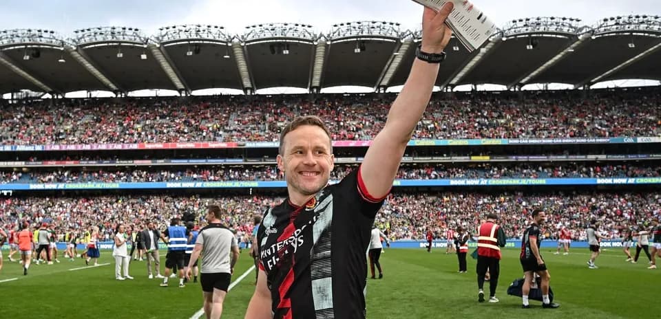 Player celebrating with fans at crowded stadium