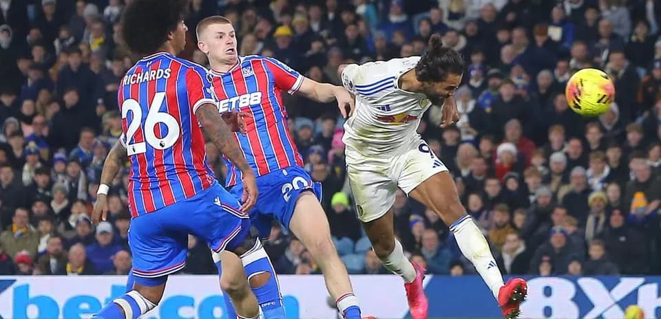 Leeds player heading the ball against Crystal Palace