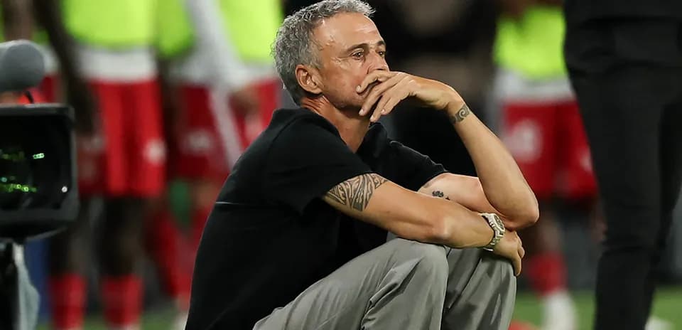 Coach sitting on the sidelines during match
