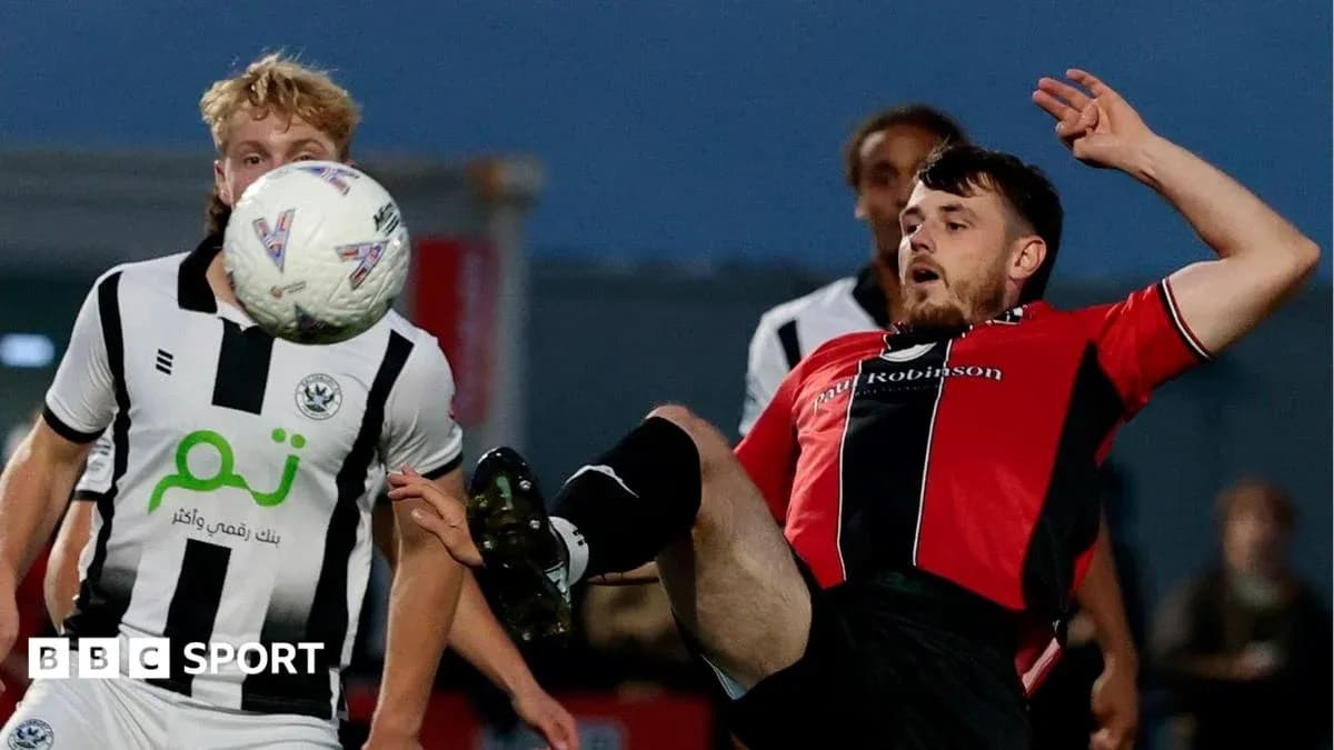 Player kicking ball while falling during match