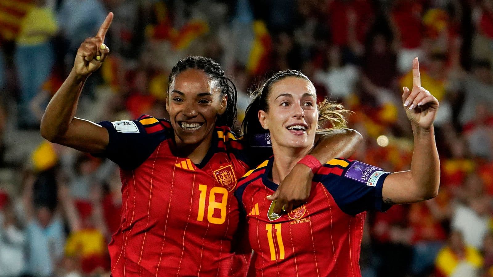 Two Spanish players celebrating a goal together
