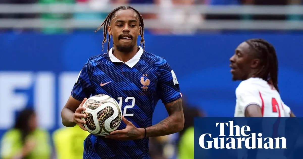 Player in France kit holding soccer ball on field