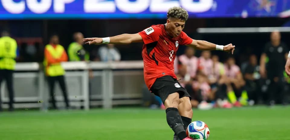Player kicking a soccer ball during match