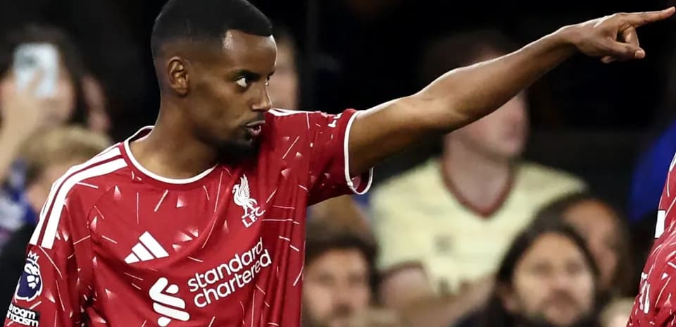 Player in Liverpool kit gesturing during match
