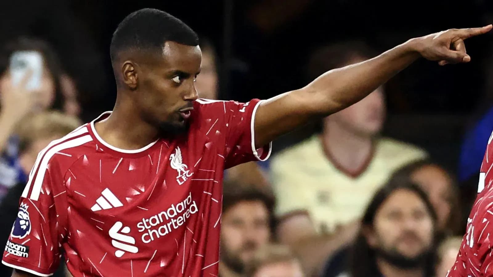 Player in Liverpool kit gesturing during match