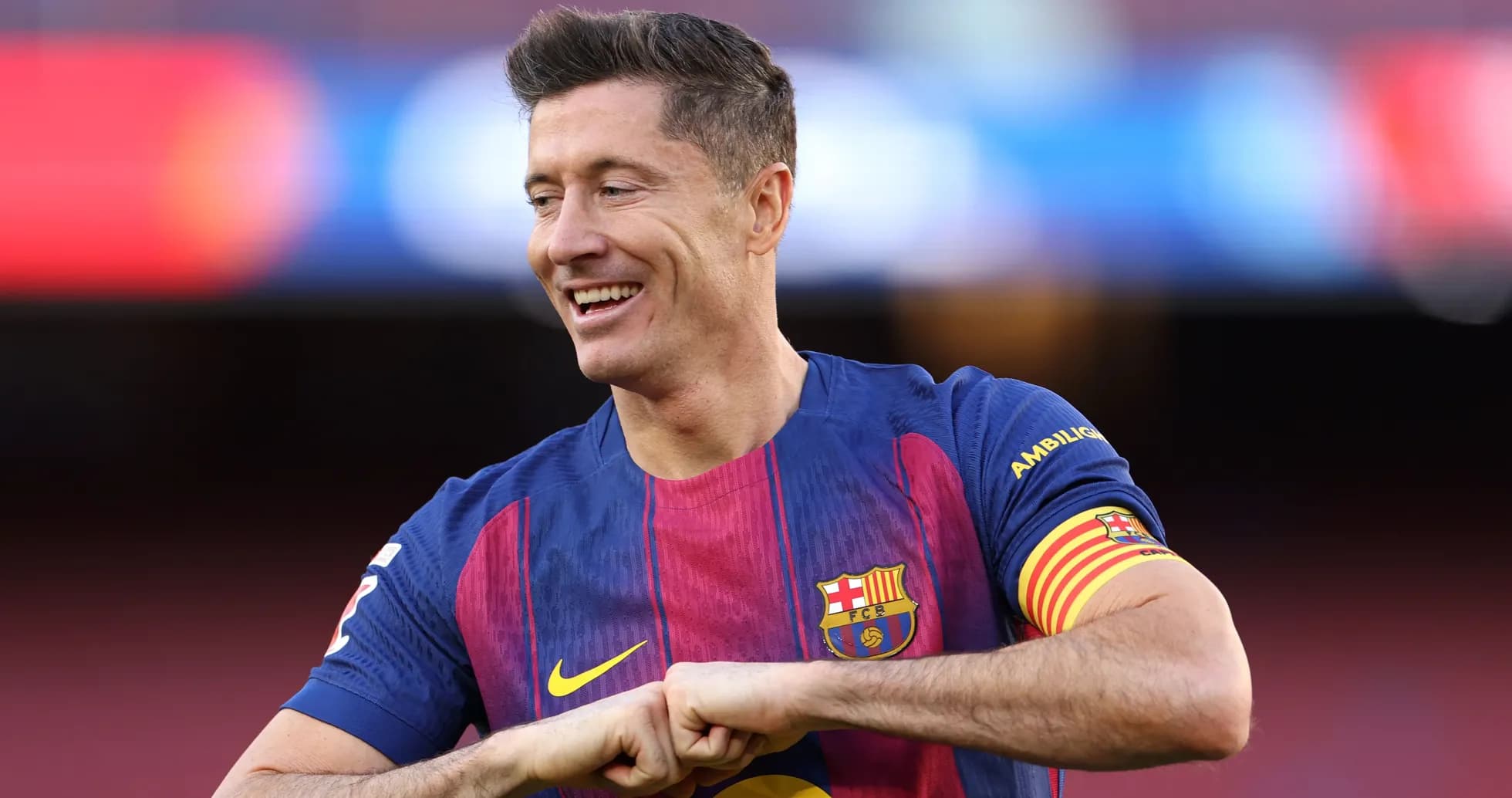Player wearing Barcelona jersey smiling on field