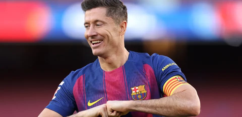 Player wearing Barcelona jersey smiling on field
