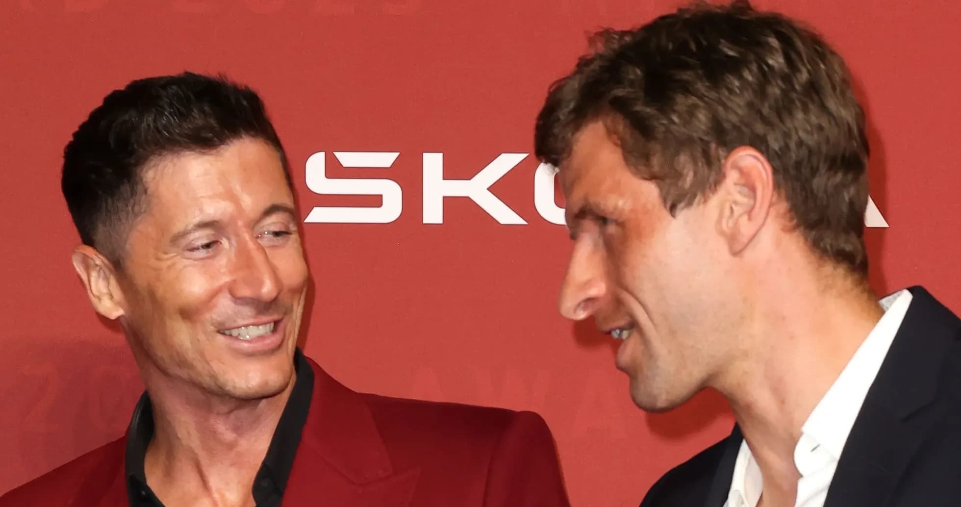Two men conversing at an award ceremony